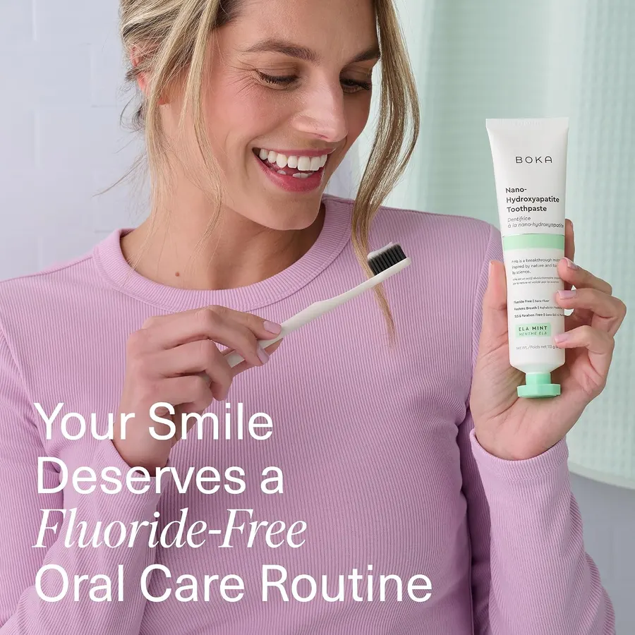 Boka Ela Mint nHA toothpaste held with a loaded toothbrush