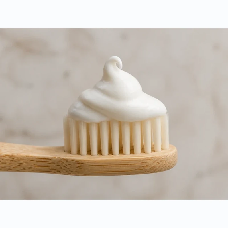 Boka toothpaste squeezed onto a bamboo toothbrush
